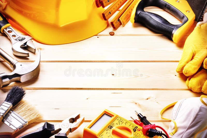 Frame with various tools on wooden background. Construction conc