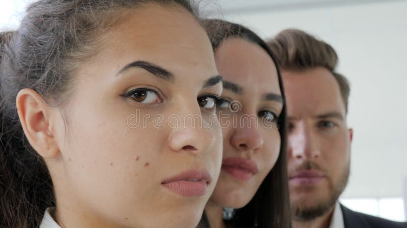 Framsida av affären, grupp av kontorsarbetare, stående av den lyckade affärslagnärbilden, allvarlig blick av ledaren med