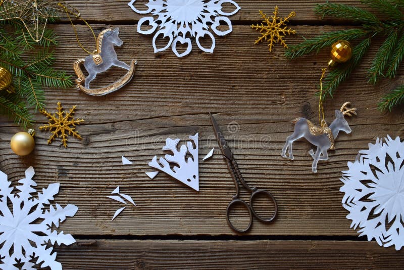 Making paper snowflakes with your own hands. Children& x27;s DIY. Merry Christmas and New Year concept. Step 2. Cut the snowflake. Making paper snowflakes with your own hands. Children& x27;s DIY. Merry Christmas and New Year concept. Step 2. Cut the snowflake