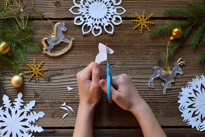 Making paper snowflakes with your own hands. Children& x27;s DIY. Merry Christmas and New Year concept. Step 2. Cut the snowflake. Making paper snowflakes with your own hands. Children& x27;s DIY. Merry Christmas and New Year concept. Step 2. Cut the snowflake