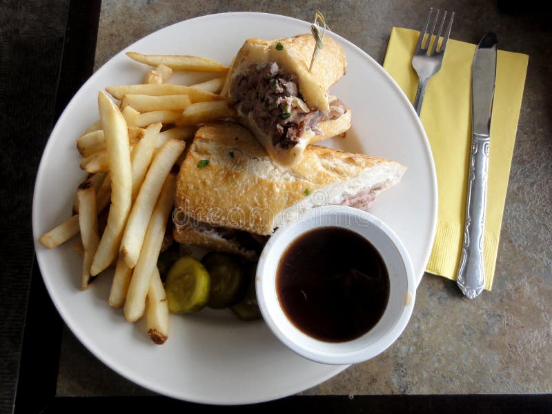 french dip sandwich. In American cuisine, the French dip sandwich, also known as a beef dip, is a hot sandwich consisting of thinly sliced roast beef on a French roll or baguette. It is served topped with Swiss Cheese, onions, and a side of sauce, pickles, and that is, with beef juice from the cooking process. french dip sandwich. In American cuisine, the French dip sandwich, also known as a beef dip, is a hot sandwich consisting of thinly sliced roast beef on a French roll or baguette. It is served topped with Swiss Cheese, onions, and a side of sauce, pickles, and that is, with beef juice from the cooking process.