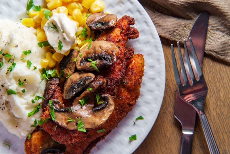 Crispy breaded chicken marsala with mashed potatoes and kernel corn. Crispy breaded chicken marsala with mashed potatoes and kernel corn