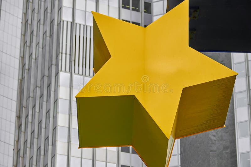 Frankfurt, Germany, October 2., 2019: Detail of a yellow star of the Euro sculpture in front of the old former building of the European Central Bank ECB