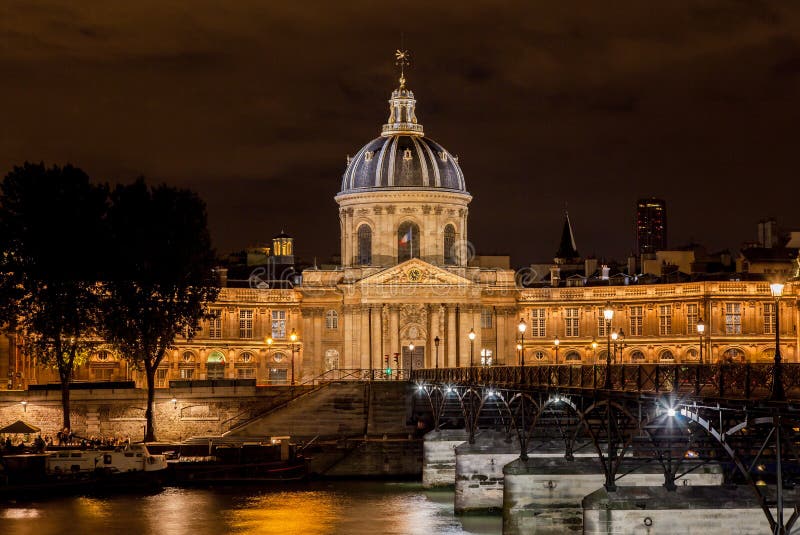 France Institut building with its dome, arches and columns at night and Pont des Arts bridge, downtown Paris, France. France Institut building with its dome, arches and columns at night and Pont des Arts bridge, downtown Paris, France.