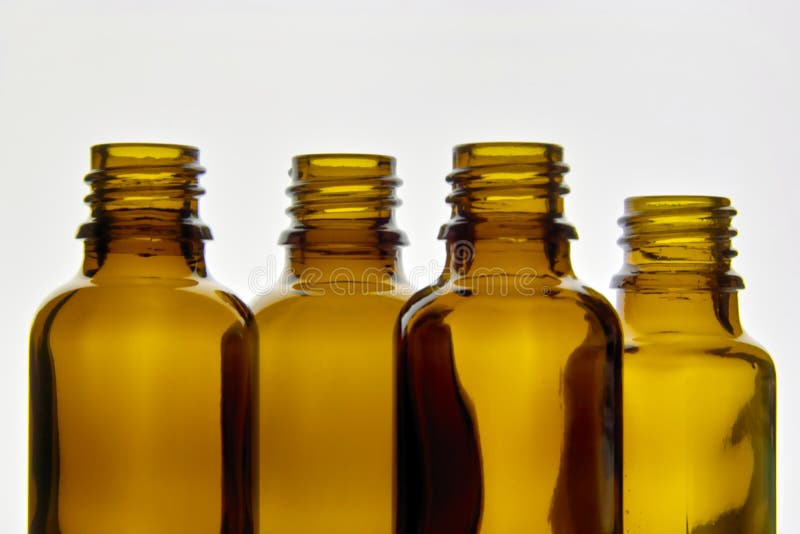 Brown Orange colored Glass Bottles used for Medicine and cosmetic Liquids, empty, isolated, illuminated. Brown Orange colored Glass Bottles used for Medicine and cosmetic Liquids, empty, isolated, illuminated