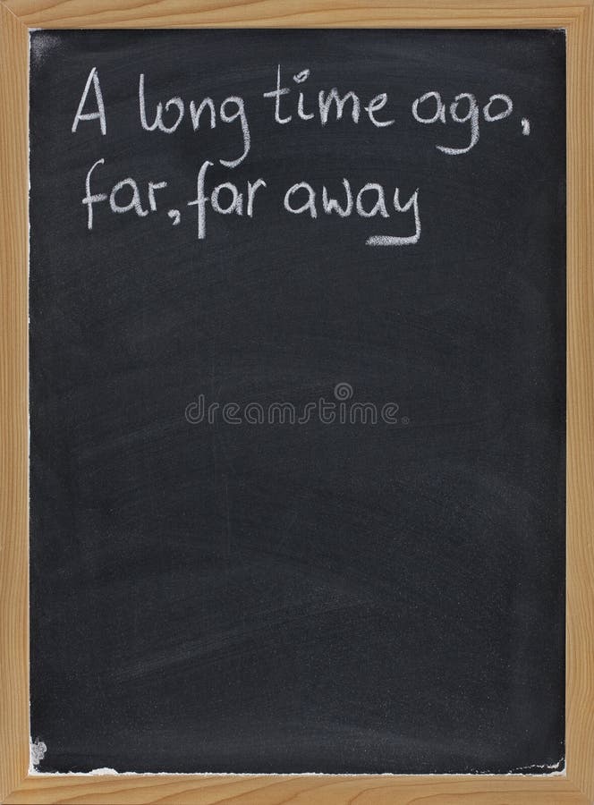 A long time ago, far, far away - a phrase for opening oral narratives, story or fairytale handwritten with white chalk on blackboard, copy space below. A long time ago, far, far away - a phrase for opening oral narratives, story or fairytale handwritten with white chalk on blackboard, copy space below