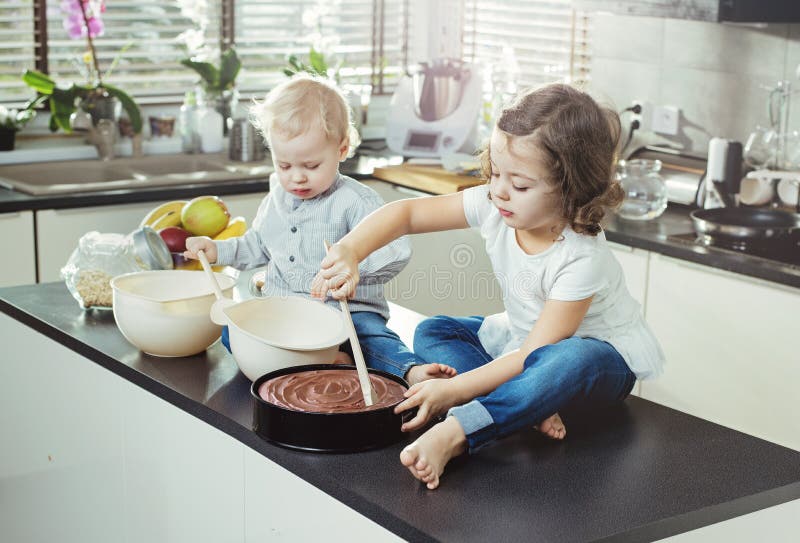 Cheerful, little siblings making a dessert. Cheerful, little siblings making a dessert