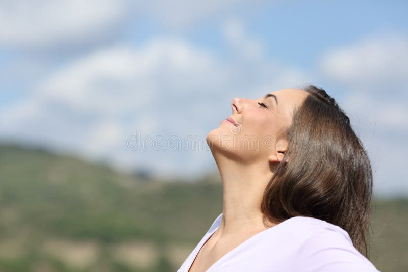 Frau atmet frische Luft in der Natur
