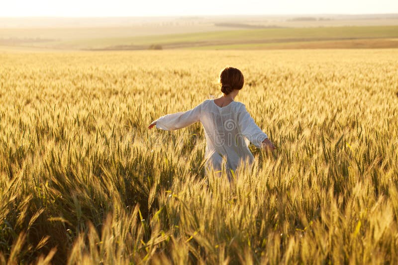 Woman in a wheat field on a summer evening. Woman in a wheat field on a summer evening