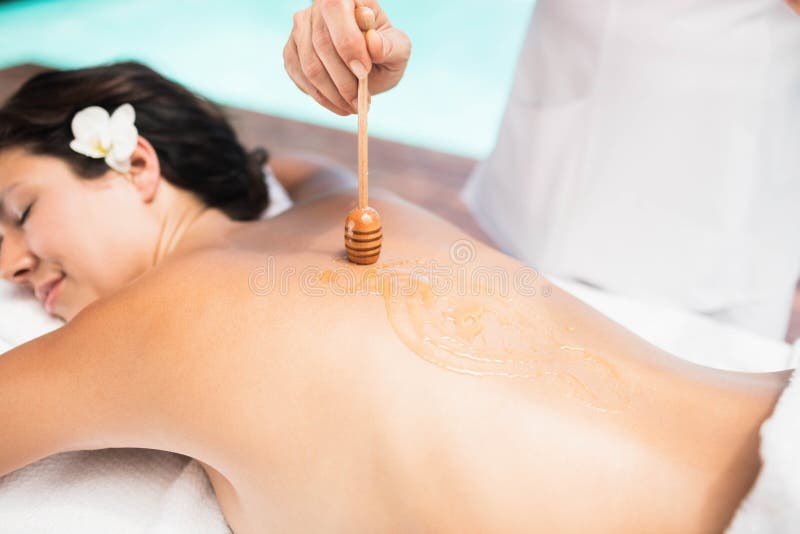 Frau, die eine Honigmassage vom Masseur empfängt lizenzfreies stockbild Frau, die eine Honigmassage vom Masseur empfängt lizenzfreies stockbild