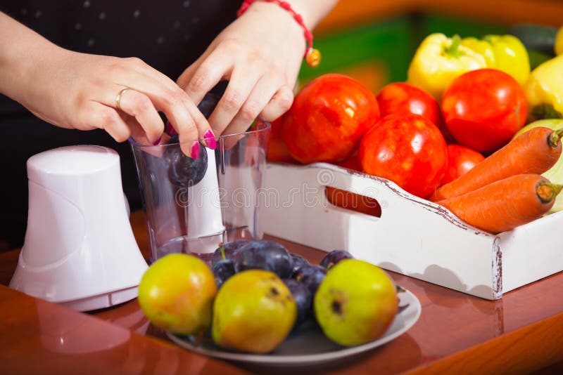 Woman using a blender to make a healthy juice. Woman using a blender to make a healthy juice