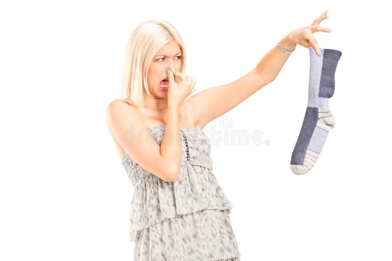 Woman holding a stinky sock isolated on white background. Woman holding a stinky sock isolated on white background