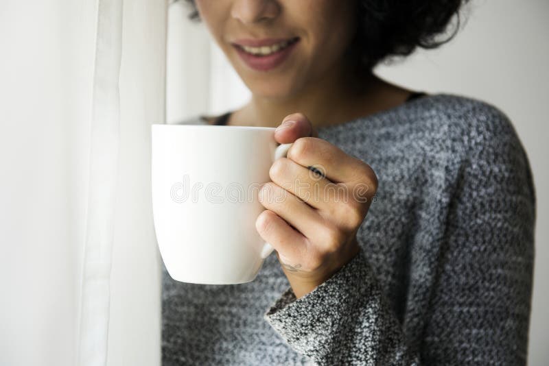 Frau hält eine Kaffeetasse lizenzfreie stockfotos