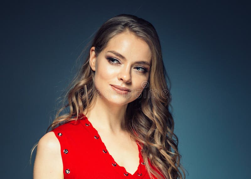 Woman in red dress with long blonde hair. Studio shot. Woman in red dress with long blonde hair. Studio shot