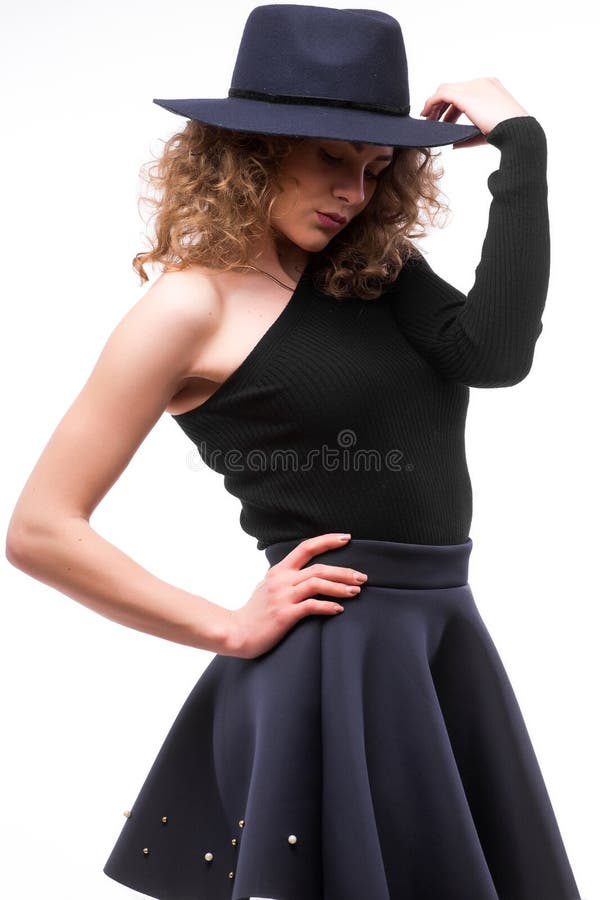 Frau mit dem gelockten Haar im schwarzen Hut und im stilvollen eleganten Abendkleid stockfoto Frau mit dem gelockten Haar im schwarzen Hut und im stilvollen eleganten Abendkleid stockfoto