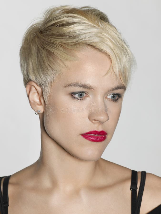 Closeup of beautiful young woman with red lips looking away on white background. Closeup of beautiful young woman with red lips looking away on white background