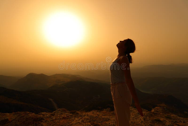 Profile of a woman silhouette breathing fresh air in the mountain at sunset. Profile of a woman silhouette breathing fresh air in the mountain at sunset