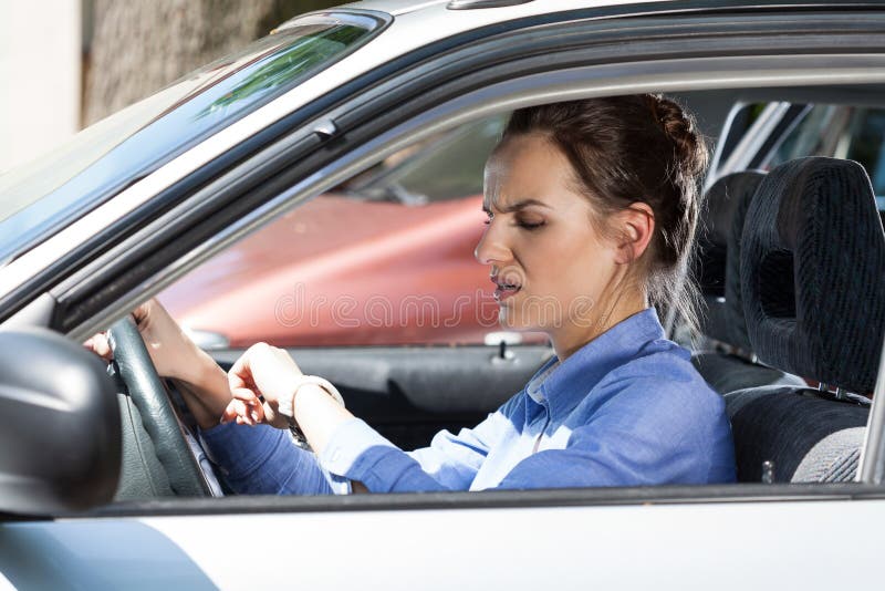 Woman late for work in a car. Woman late for work in a car