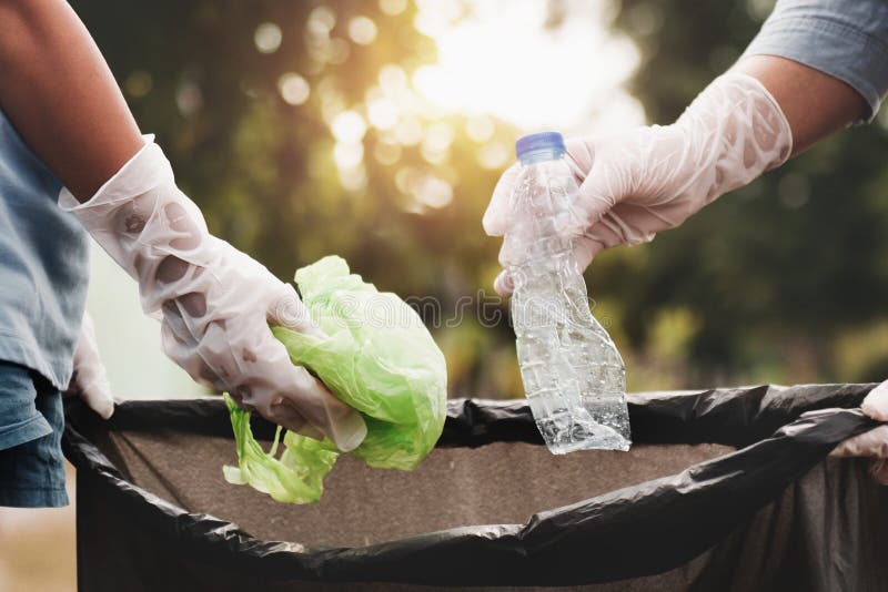 woman hand picking up garbage plastic for cleaning at park. woman hand picking up garbage plastic for cleaning at park