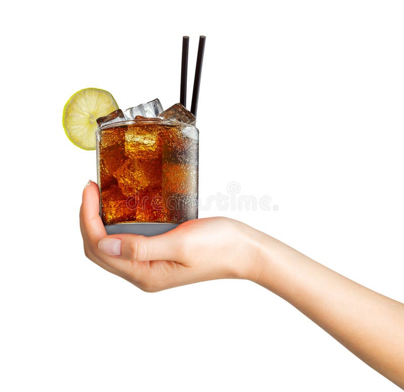 Woman hand holding cocktail in old fashioned glass with ice cubes and black straw on white background. Woman hand holding cocktail in old fashioned glass with ice cubes and black straw on white background.