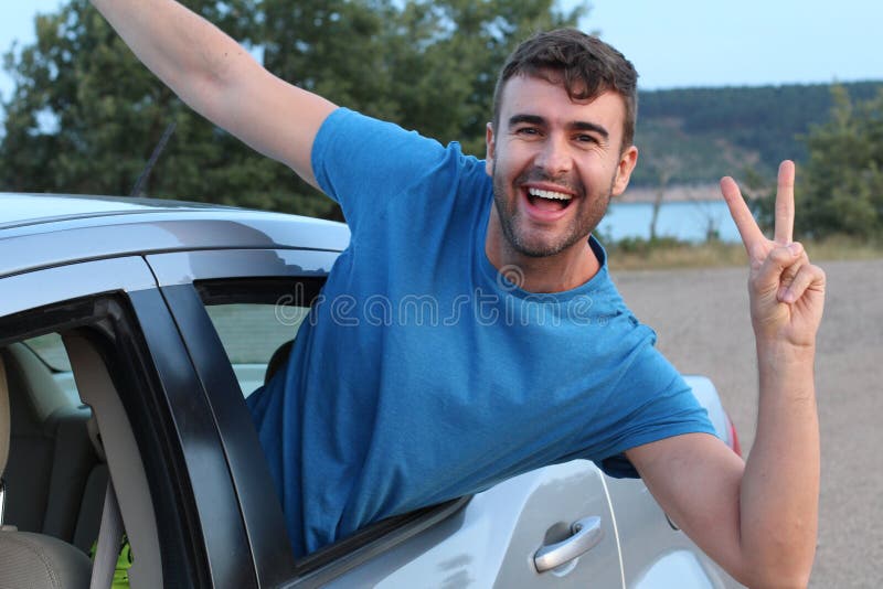 Free spirited car passenger showing peace sign