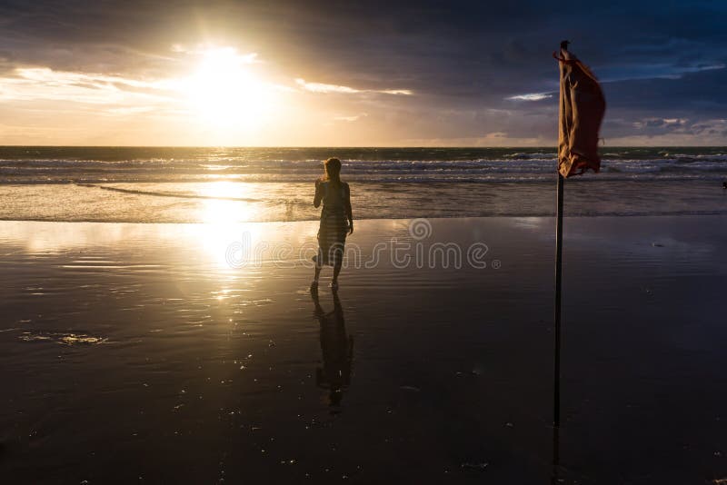 Free woman enjoying freedom feeling happy at beach at sunset. Beautiful serene relaxing woman in pure happiness and royalty free stock image Free woman enjoying freedom feeling happy at beach at sunset. Beautiful serene relaxing woman in pure happiness and royalty free stock image