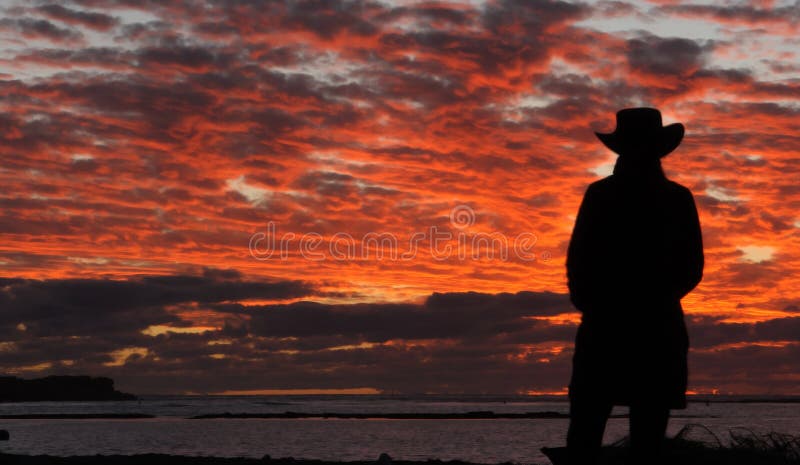 cowboy on a lake at sunset stock images cowboy on a lake at sunset stock images