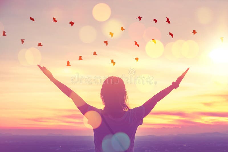 Freedom feel good and travel adventure concept. Copy space of silhouette woman rising hands on sunset sky at top of mountain and