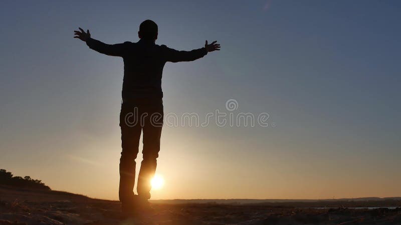 Freedom Man Stands On A Cliff Sunset Silhouette Hand In The Sides