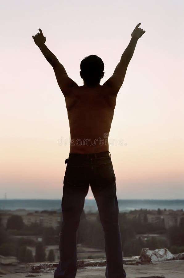 Freedom. Silhouette young man stock photo
