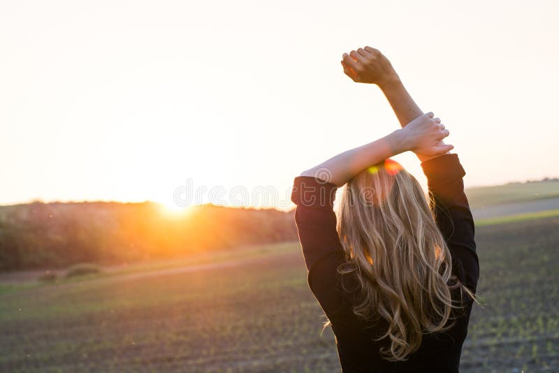 Happy Woman Jumping And Enjoying Life In Field At Sunset In Mountains Stock  Photo, Picture and Royalty Free Image. Image 97035120.