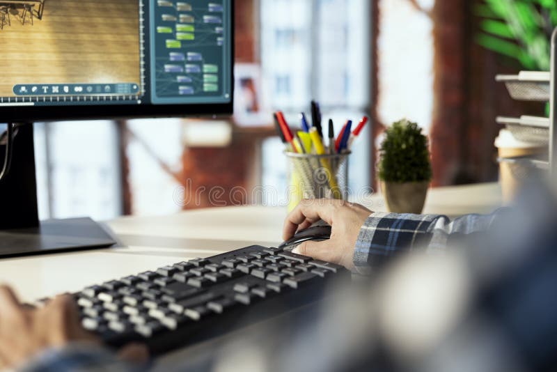Close up of man making floor plan in CAD software stock photo