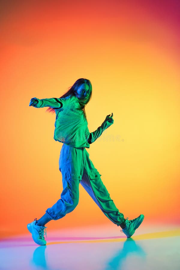 Young Sportive Girl Dancing Hip-hop in Stylish Clothes on Colorful  Background at Dance Hall in Neon Light. Youth Culture Stock Photo - Image  of cheeky, clothes: 229831994