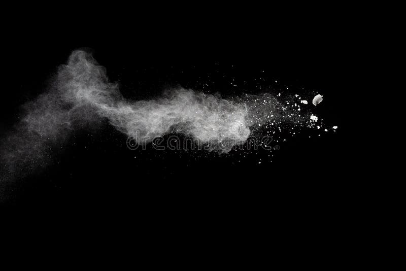 Freeze motion of white dust particles splash on black background.White powder explosion clouds