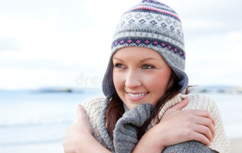 Freezing pretty woman wearing a hat