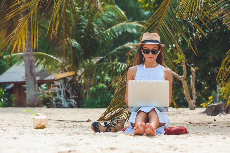Freiberufler der jungen Frau, der im Laptop auf dem Strand arbeitet Freiberufliche Tätigkeit stockfoto Freiberufler der jungen Frau, der im Laptop auf dem Strand arbeitet Freiberufliche Tätigkeit stockfoto