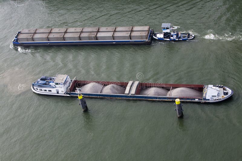 Aerial view of two barges loaded with cargo containers and bulk, passing on the River. Barges rotterdam stock images, royalty-free photos and pictures
