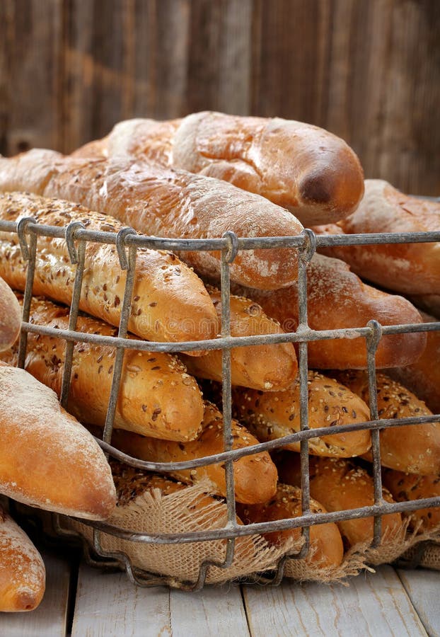 French baguettes in metal basket in bakery.