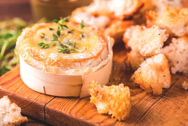 French baked Camembert cheese with thyme and baguette bread