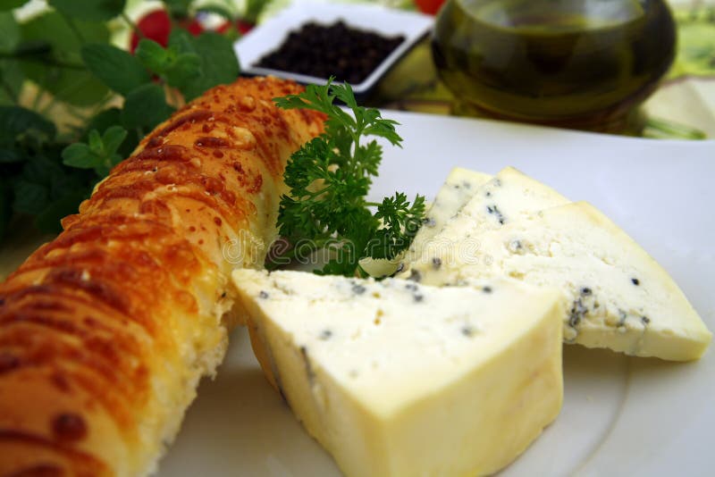 French cheese and bread with cheese, wine, some herbs, nuts and pepper. French cheese and bread with cheese, wine, some herbs, nuts and pepper