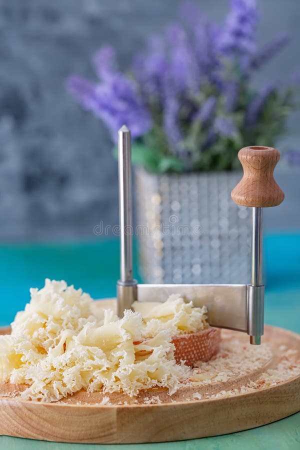 Swiss Cheese with Crumbs on a Wooden Surface and a Decorative Tablecloth  and Beautiful White Roses. Soft Focus. Stock Image - Image of cracks, blue:  190468939