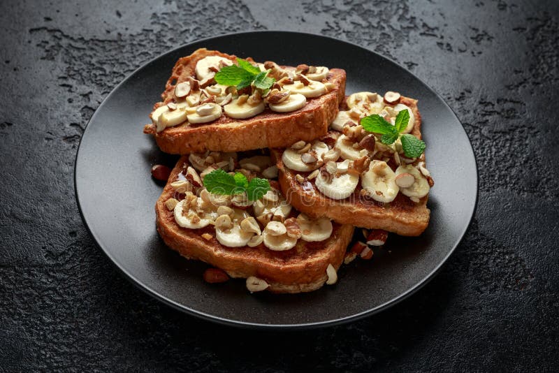 French Cinnamon Toast with Banana, Nuts and Hazelnut, Honey. Stock