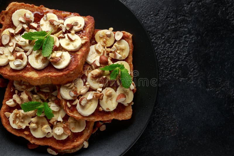 French Cinnamon Toast with Banana, Nuts and Hazelnut, Honey. Stock