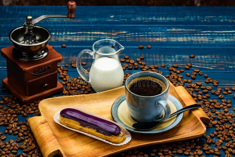 French Coffee with Cream and Eclair and Coffee Beans Stock Image