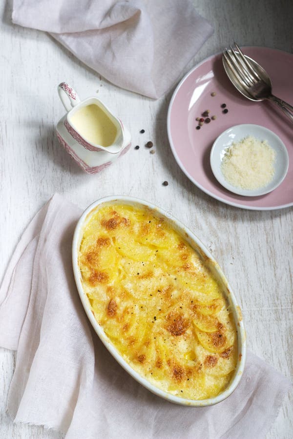 French Dish Gratin Dauphinois in Ceramic Form on a Light Background