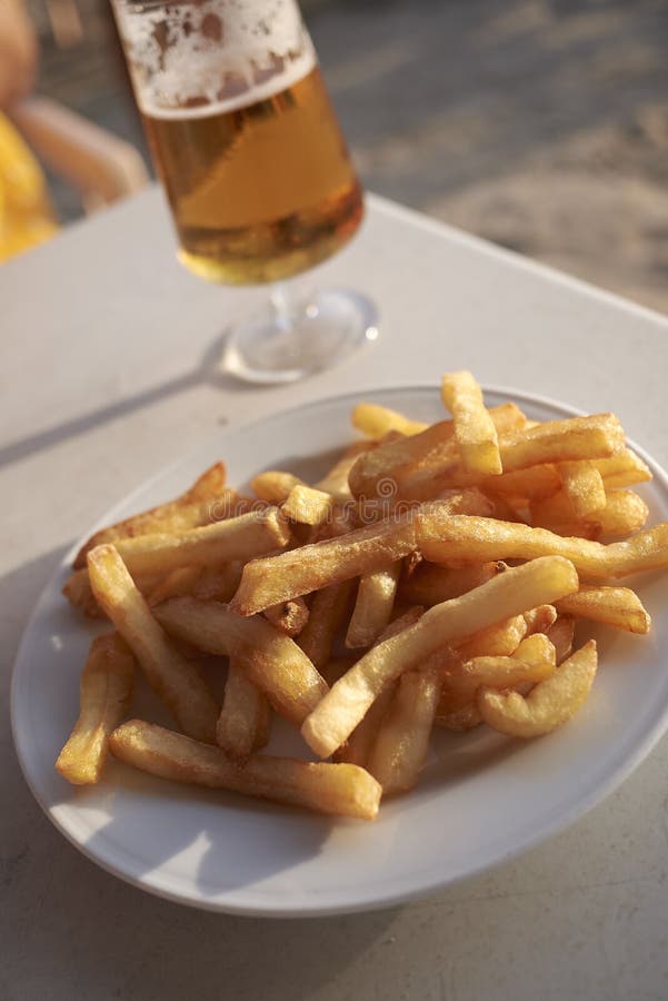 French fries and a beer stock image. Image of crisps 158268697