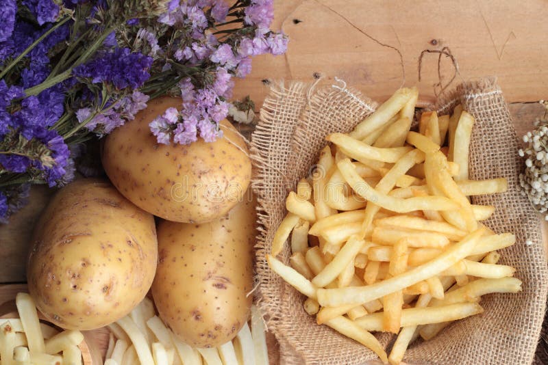 French Fries and Fresh Sliced Potatoes with Ketchup. Stock Photo