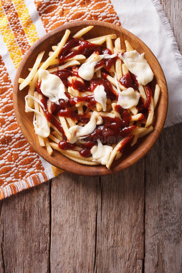 French Fries with Gravy and Cheese. Vertical Top View Stock Photo