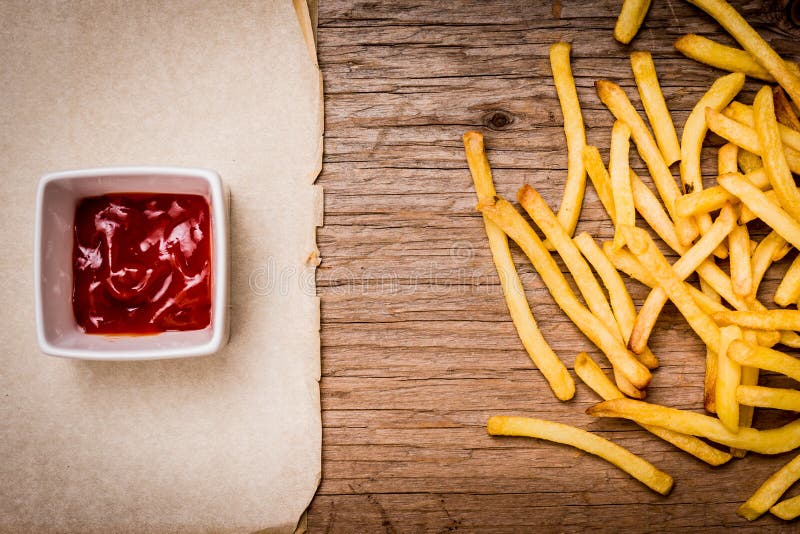 French Fries Ketchup And Paper On A Wooden Table Stock Photo Image