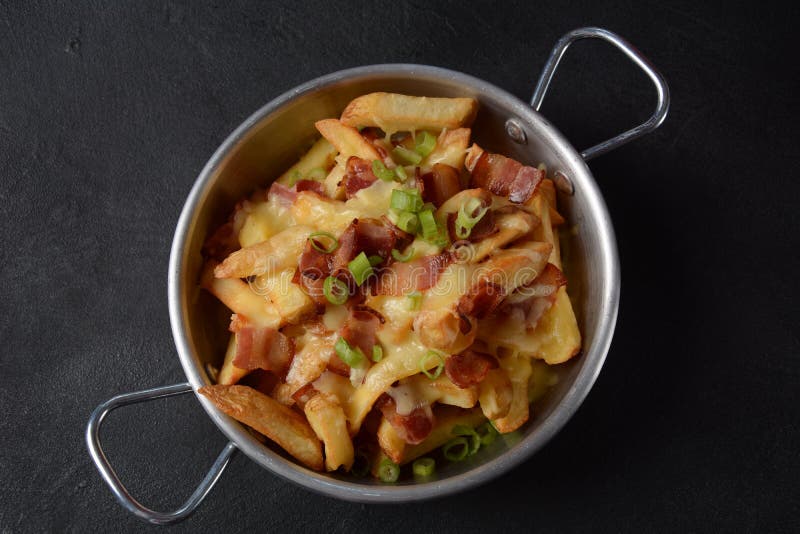French Fries with Melted Cheddar Cheese with Crispy Bacon. Poutine with